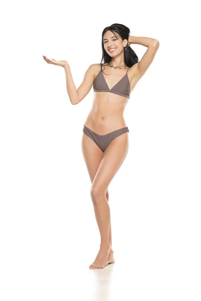 Ung Leende Brunett Kvinna Bikini Baddräkt Reklam Imaginära Objekt Hennes — Stockfoto