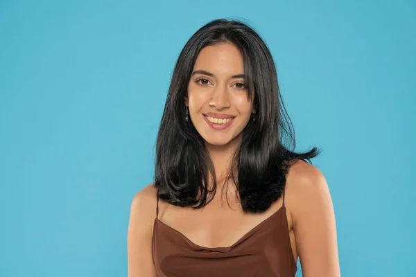 Portrait of yong positive woman , big smile, beautiful model posing in studio over blue background. Caucasian portrait woman.