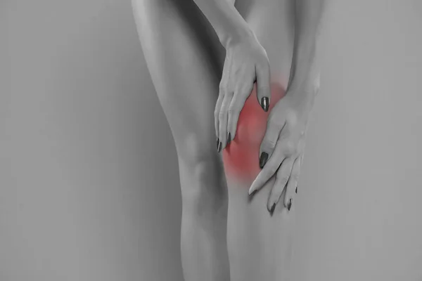 Woman Holding Her Painful Knee Blue Studio Background — Foto Stock