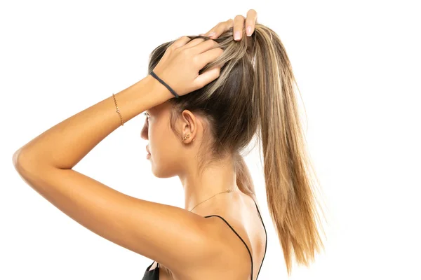 Young Beautiful Woman Tying Her Hair Ponytail White Studio Background — Stock Photo, Image