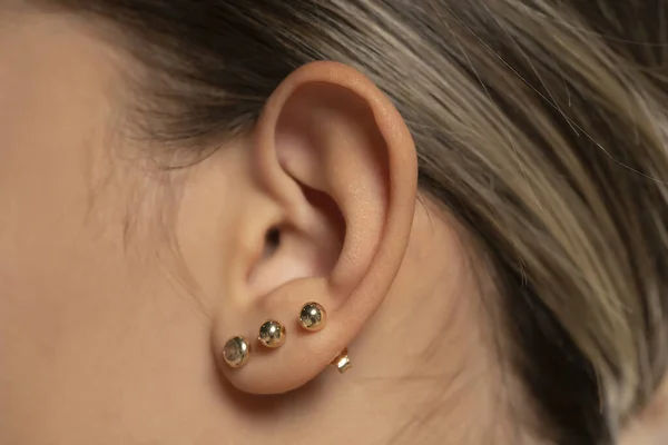 Female Ear Three Earrings Close — Stock Photo, Image
