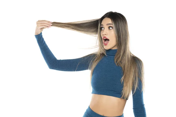 Excited Young Woman Holding Her Long Hair White Studio Background — Stock Photo, Image