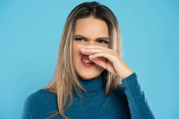 Young Woman Has Itching Nose Blue Studio Background — Stock Photo, Image