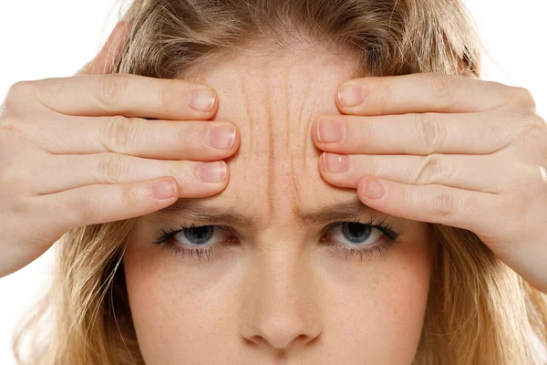 Portrait Young Unhappy Woman Showing Her Wrinkles Her Forehead White — Stock Photo, Image