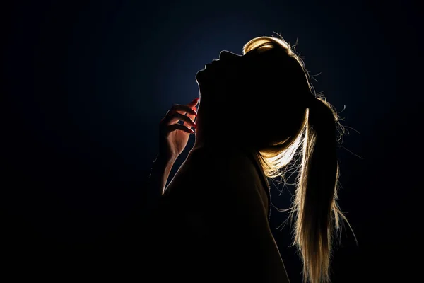 Silhouet Van Vrouwenhoofd Met Paardenstaart Die Haar Nek Raakt Achterlicht — Stockfoto