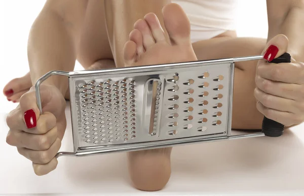 Woman Scrapes Her Feet Kitchen Grater White Studio Background — Stock Photo, Image