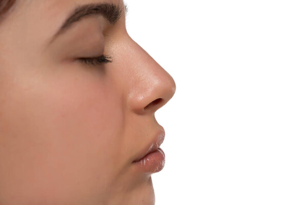 Closeup nose and mouth of a young woman on a white studio background