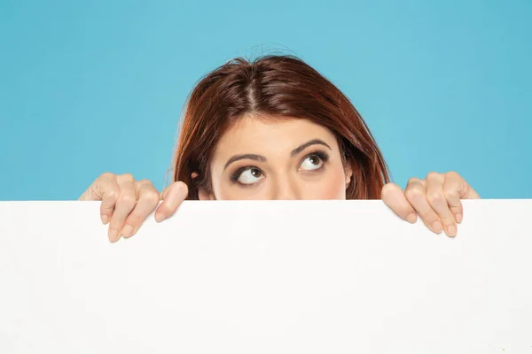 Banner Young Thinking Redhead Woman Peeking Empty White Canvas Frame — Stock Photo, Image