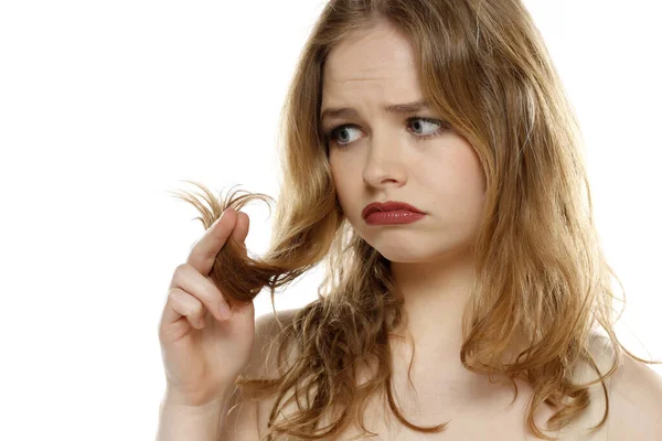 Pretty Unhappy Woman Looking Her Hair White Studio Background — Stock Photo, Image