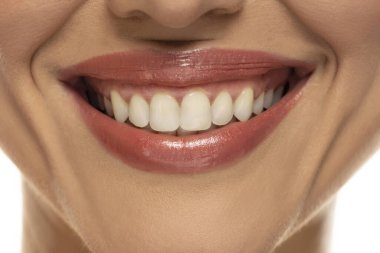 Close-up of a woman's mouth, capturing a confident smile and perfect natural teeth and lips. clipart