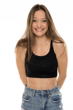 Güzel bir kadın beyaz bir stüdyoda gülüyor.