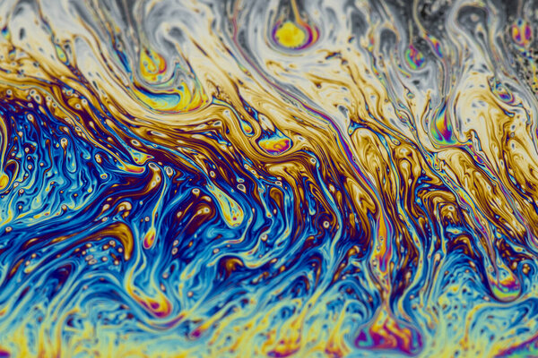 Abstract background of a Dynamic interference colors in thin soap films. Bubble rainbow colors