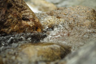 Motion blurred of water flows on the stone in the stream