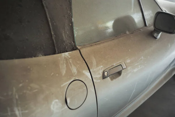 stock image The full of dust covered on the old car abandoned in the parking lot