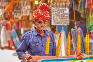 PUSHKAR, INDIA - MARCH 3 2018: Colorful scene of ice cream seller seling on the street of the Holy City.
