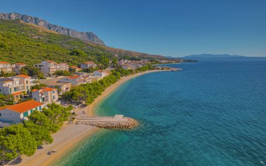 Aerial view of sunny pebble beach in Tucepi town on Adriatic coast in Croatia.