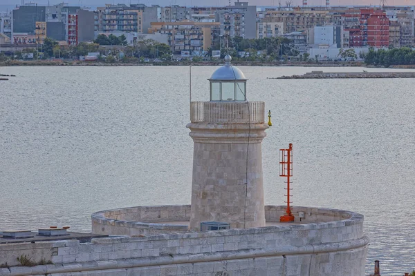 Old stone lighthouse in the Bari city port, Italy.