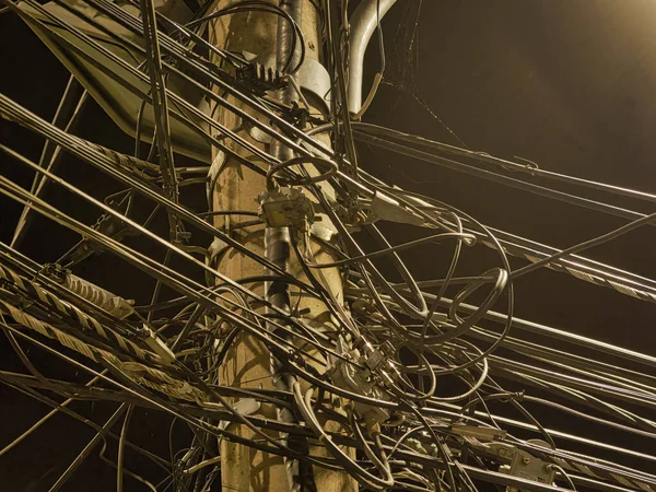 Eski Kasabanın Karanlık Caddesinde Kablolar Birbirine Dolanmış Bir Elektrik Direği — Stok fotoğraf