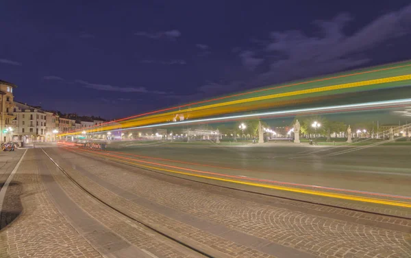 stock image PADUA, ITALY - APRIL 01 2023: Long exposure night view capturing the light trail of a tram at Prato della Valle park.