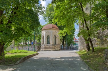 Bihac, Bosnia and Herzegovina - June 2, 2023: Vibrant view of the historic city center featuring the iconic stone Turbe in the foreground.