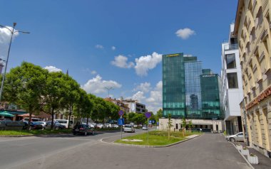BIHAC, BOSNIA AND HERZEGOVINA - June 2, 2023: The modern glass facade of the Euroherc building reflects the bustling heart of the city.