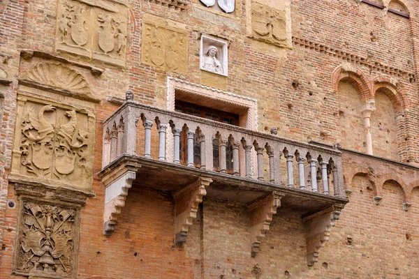 Antique balcony overlooking quaint medieval alley in the heart of an old town in Padua Italy.