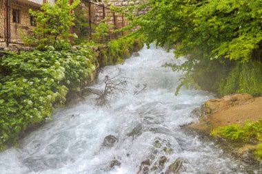 Ethereal mist shrouds the mesmerizing Plava Voda spring in Travnik, capturing the serene beauty of natures wonders. clipart