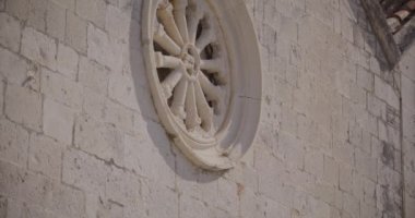 Hırvatistan 'ın Komiza kentinde bulunan ve aynı zamanda Gusarica olarak da bilinen St. Mary Katolik Kilisesi' nin güzelliğini yansıtan sakin bir kamera tavası, yukarıda filizlenen süs süsleri ve kapari çalılarını gözler önüne seriyor..