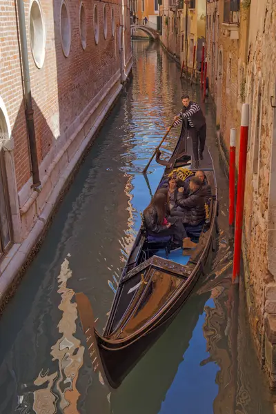 Venice Italy April 2023 Gondolier Skillfully Navigates Winding Canal Venices Royalty Free Stock Images