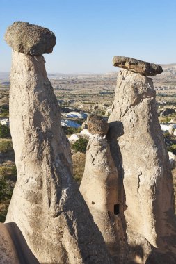 Picturesque chimney rock formations in Cappadocia. Urgup village. Turkey