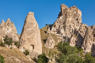 Ancient stone houses caves in Usichar fortress village. Cappadocia. Turkey