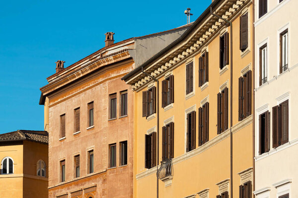 Traditional colored buildings facades in Rome city center. Italy