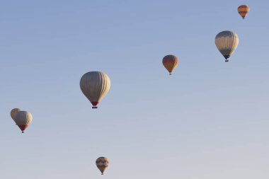 Spectacular balloons flying at sunrise in Goreme valley. Cappadocia, Turkey