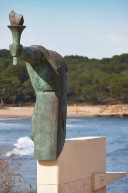 Olympic torch memorial in LEscala, Girona. Catalonia, Mediterranean coast, Spain clipart