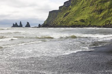 Reynisdrangur kaya tepeleri ve siyah kumsal. Vik, İzlanda deniz manzarası