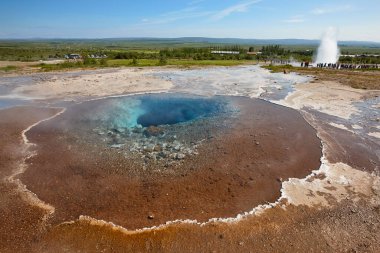 Strokkur gayzerleri kaynar su püskürtüyor. İzlanda tarihi doğa cazibesi