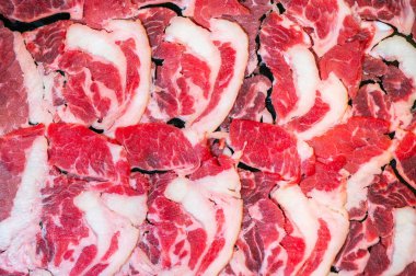 Slide raw beef for Yakiniku. Thin piece beef for Shabu hotpot japanese food style. Close up fresh meat chuck eye for Sukiyaki. top view.