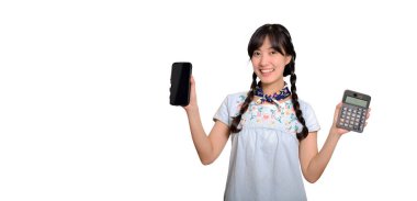 Portrait of beautiful happy young asian woman in denim dress holding calculator and smartphone on white background. business shopping online concept.