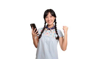 Portrait happy beautiful young asian woman in denim dress using a smartphone on white background