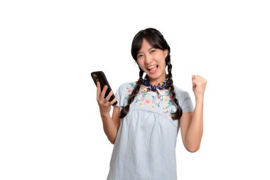 Portrait happy beautiful young asian woman in denim dress using a smartphone on white background