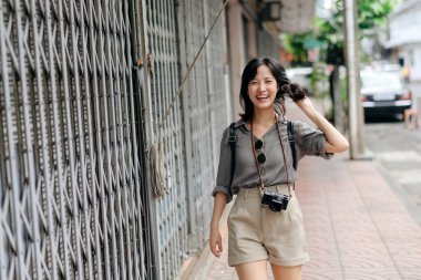 Young Asian woman backpack traveler enjoying street cultural local place and smile.