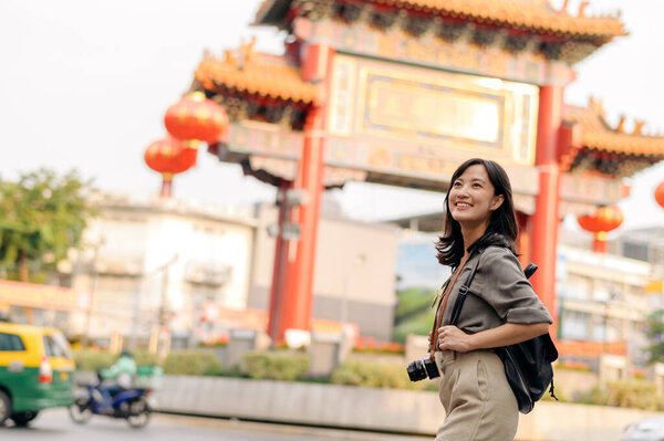 Young Asian woman backpack traveler enjoying China town in Bangkok, Thailand.