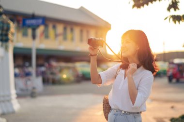 Asian woman traveler using camera. Asia summer tourism concept