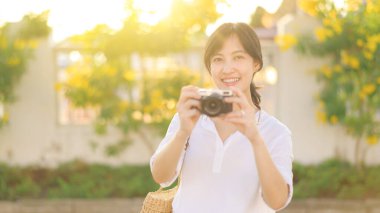 Asian woman traveler using camera. Asia summer tourism concept