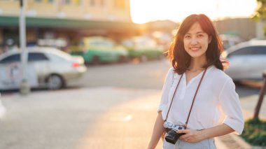 Asian woman traveler using camera. Asia summer tourism concept