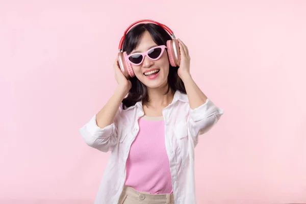 유행하는 선글라스를 착용하고 아시아인 모델은 헤드폰 오디오로 음악을 스튜디오 배경에서 — 스톡 사진