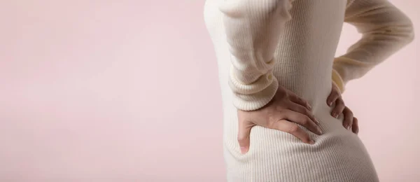 Young woman have back ache, waist pain, lumbar muscle injury problem. Office syndrome disease sick. Healthcare concept.