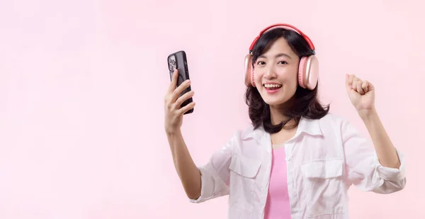 Szczęśliwie Uśmiechnięta Młoda Azjatka Tańcząca Zrelaksowana Smartfonem Słuchająca Muzyki Bezprzewodowych — Zdjęcie stockowe