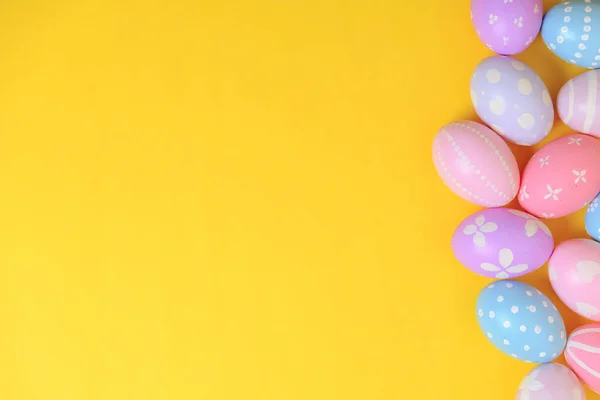 stock image Happy easter holiday celebration concept. Group of painted colourful eggs decoration on a yellow background. Seasonal religion tradition design. Top view, copy space, flat lay.