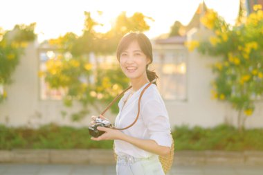 Asian woman traveler using camera. Asia summer tourism concept